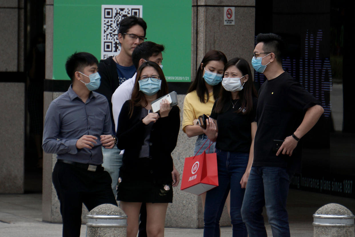 Office workers in face masks seen in the central business district on 7 April 2020, the first day of Singapore&#39;s month-long circuit breaker period. (PHOTO: Dhany Osman / Yahoo News Singapore)