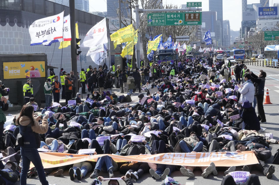 Members of the Korean Confederation of Trade Unions stage die-in during a rally marking International Women's Day in Seoul, South Korea, Friday, March 8, 2024. (AP Photo/Ahn Young-joon)