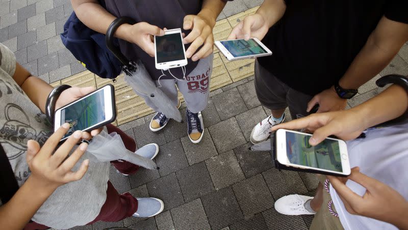 People maneuver their smartphones as they play “Pokemon Go” at Akihabara in Tokyo, Friday, July 22, 2016. The Icelandic yogurt company, siggi, announced their Digital Detox Program challenge.