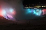 A partially frozen base of Horseshoe Falls is seen on lit by lights during sub freezing temperatures in Niagara Falls, Ontario March 3, 2014. REUTERS/Mark Blinch