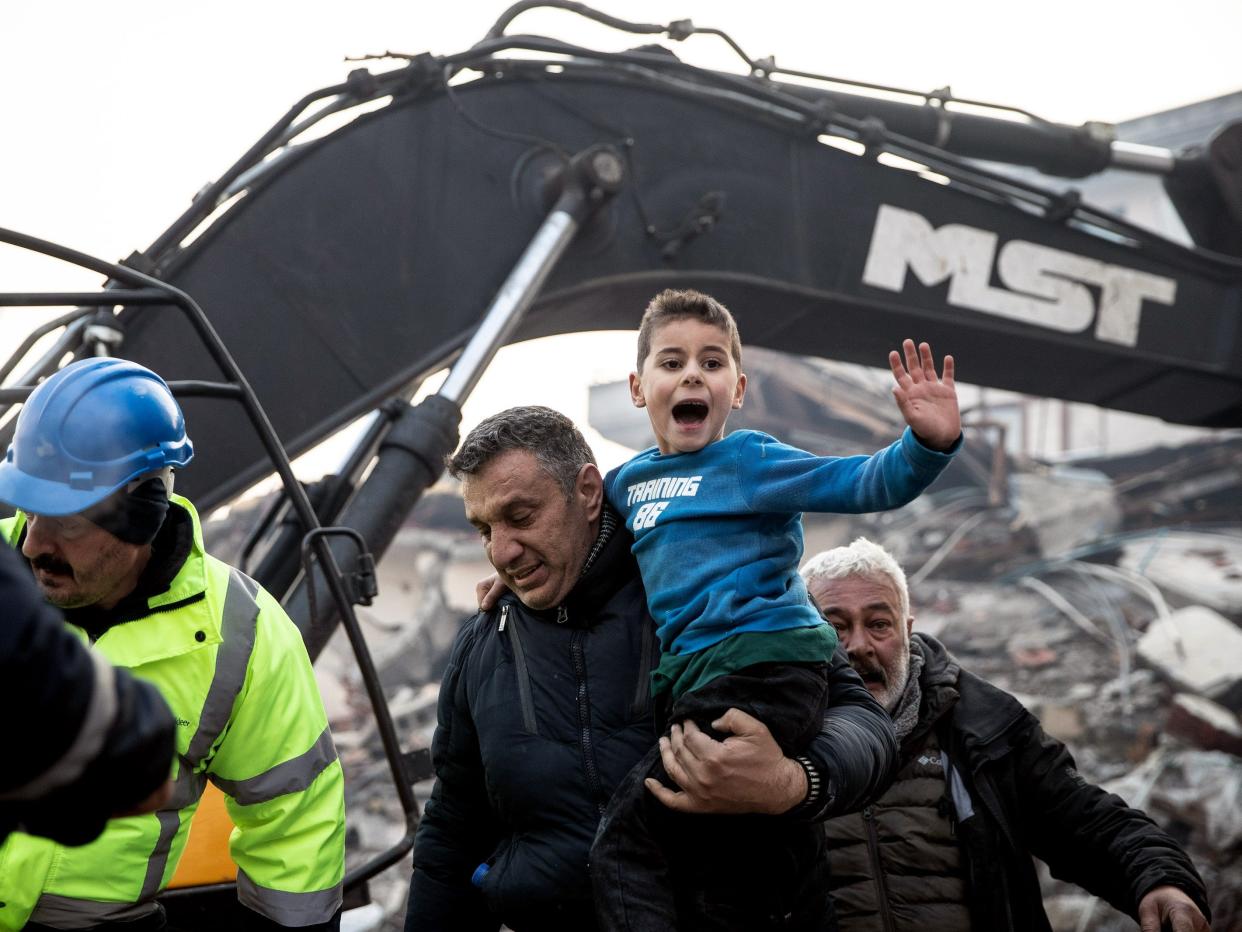 Rescue workers carry 8-year-old survivor Yigit at the site of a collapsed building 52 hours after an earthquake struck on February 08, 2023 in Hatay, Turkey. A 7.8-magnitude earthquake hit near Gaziantep, Turkey early Monday, followed by another 7.5-magnitude tremor just after midday.