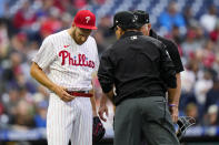 Philadelphia Phillies pitcher Zack Wheeler, left, is checked by umpires after the first inning of a baseball game against the Washington Nationals, Tuesday, June 22, 2021, in Philadelphia. (AP Photo/Matt Slocum)