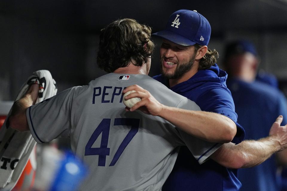 Los Angeles Dodgers pitcher Clayton Kershaw (22) congratulates starting pitcher Ryan Pepiot (47) on a great outing against the Miami Marlins at loanDepot Park.