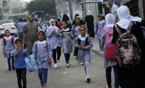 Students walk to the United-Nation run Elementary School on the first day of the new school year at the Shati refugee camp in Gaza City, Saturday, Aug. 8, 2020. Schools run by both Palestinian government and the U.N. Refugee and Works Agency (UNRWA) have opened almost normally in the Gaza Strip after five months in which no cases of community transmission of the coronavirus had been recorded. (AP Photo/Adel Hana)