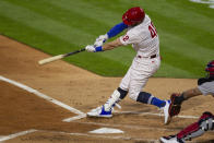 Philadelphia Phillies Bryce Harper swings on an RBI double during the second inning of the team's baseball game against the St. Louis on Cardinals, Friday, April 16, 2021, in Philadelphia. (AP Photo/Laurence Kesterson)