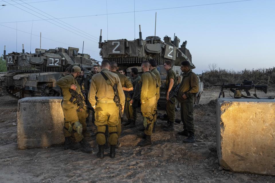 Israeli soldiers stand by tanks near the Israel Gaza border, Tuesday, May 2, 2023. The Israeli military says that Palestinian militants in Gaza have fired a barrage of rockets following the death of Khader Adnan, a high-profile Palestinian prisoner in Israeli custody after a nearly three-month-long hunger strike. (AP Photo/Tsafrir Abayov)