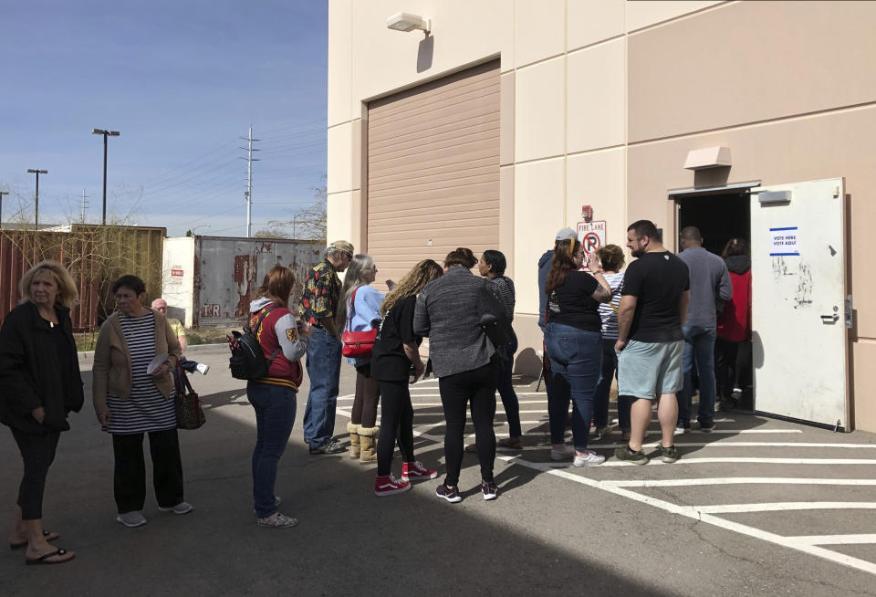 Democratic caucus-goers wait more than an hour in line in an early caucus ballot precinct site at an AFL-CIO union office in Henderson, Nev., Saturday, Feb. 15, 2020. Voters filled out ballots with first, second and third choice picks, to be tallied Saturday, Feb. 22, in the Nevada Democratic Party caucus. (AP Photo by Ken Ritter)