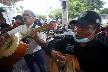 Men entertain people who are staying at a shelter set up by the army after an earthquake, in Jojutla de Juarez, Mexico September 21, 2017. REUTERS/Edgard Garrido