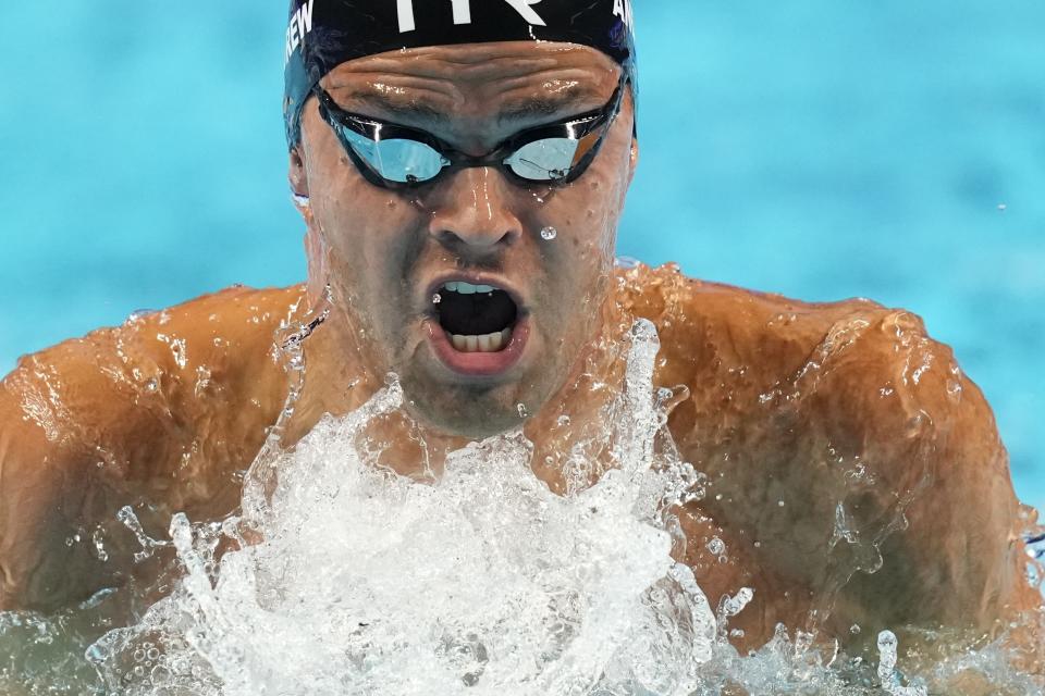 Michael Andrew participates in the men's 100 breaststroke during wave 2 of the U.S. Olympic Swim Trials on Sunday, June 13, 2021, in Omaha, Neb. (AP Photo/Charlie Neibergall)