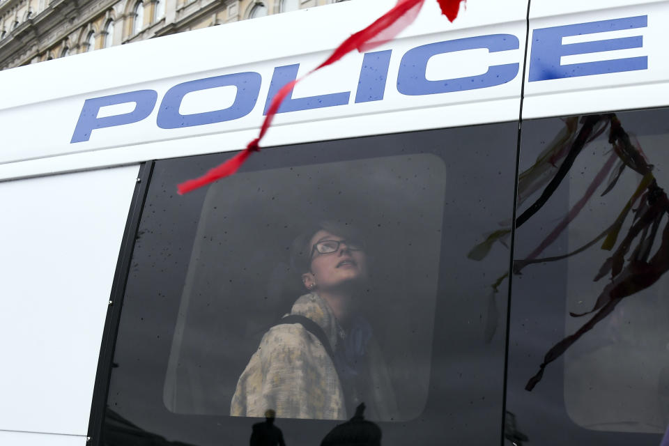 A climate activist is see through a window of a police van during an Extinction Rebellion protest in London, Oct. 7, 2019. (Photo: Alberto Pezzali/AP)