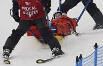 Germany's Anna Woerner is carried off course by medical staff following a fall during the women's freestyle skiing skicross quarter-finals at the 2014 Sochi Winter Olympic Games in Rosa Khutor, February 21, 2014. The 24-year-old's left leg appeared to give way on impact as she hit the icy landing slope after losing control over a big jump. She turned cartwheels before coming to rest and received lengthy medical attention on the course. REUTERS/Dylan Martinez (RUSSIA - Tags: SPORT SKIING OLYMPICS)