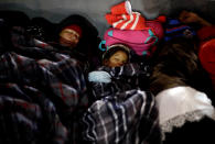 <p>Members of a caravan of migrants from Central America sleep near the San Ysidro checkpoint after a small group of fellow migrants entered the United States border and customs facility, where they are expected to apply for asylum, in Tijuana, Mexico April 29, 2018. (Photo: Edgard Garrido/Reuters) </p>