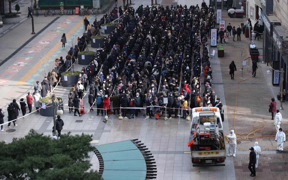 Residents in Daegu wait in line to buy face masks on Tuesday - YONHAP/AFP via Getty Images