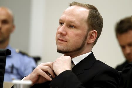 Norwegian mass killer Anders Behring Breivik adjusts his tie as the Oslo Court delivered the verdict of his trial in Oslo Courthouse, Norway, in this August 24, 2012 file photo. REUTERS/Heiko Junge/NTB Scanpix/Pool/Files