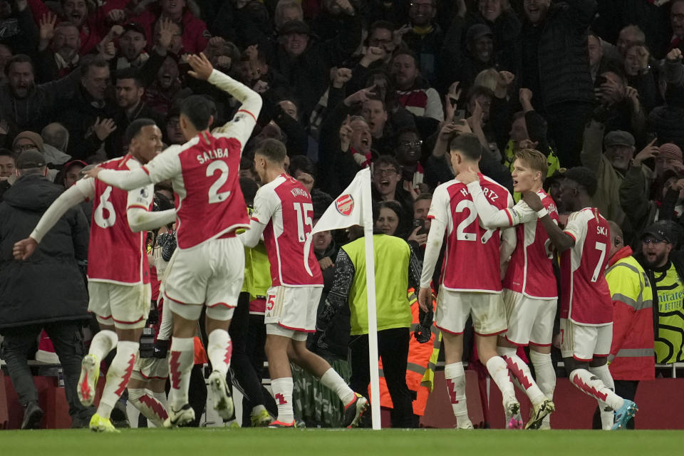 Arsenal players celebrate after their teammate Gabriel Martinelli scored their side's second goal during the English Premier League soccer match between Arsenal and Liverpool at Emirates Stadium in London,, Sunday, Feb. 4, 2024. (AP Photo/Kin Cheung)