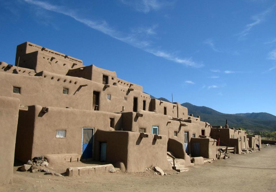 This October 2012 photo shows adobe dwellings at the Taos Pueblo in Taos, N.M., a UNESCO World Heritage site where the Taos native people have lived for 1,000 years. Tours of the pueblo describe the community’s survival and challenges across the centuries. The picture-perfect dwellings are multi-level, often with ladders to reach upper floors and round ovens outside. (AP Photo/Beth Harpaz)