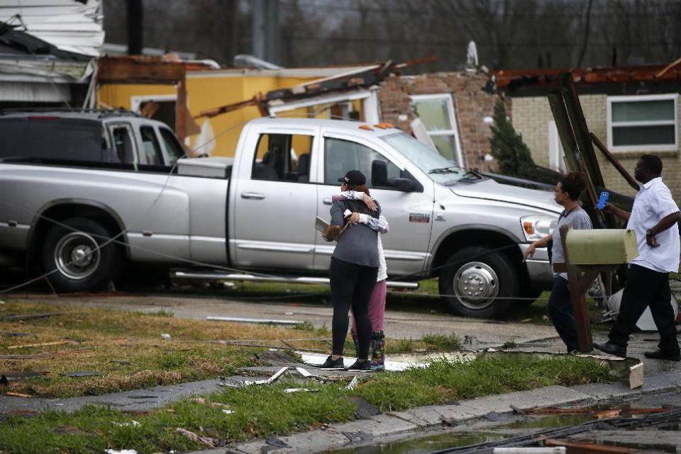 People hug after a tornado tore through the eastern part of New Orleans, Tuesday, Feb. 7, 2017. The National Weather Service says at least three confirmed tornadoes have touched down, including one inside the New Orleans city limits. Buildings have been damaged and power lines are down. (AP Photo/Gerald Herbert)