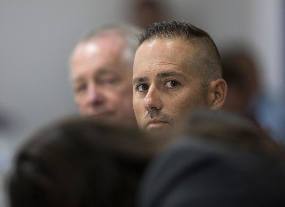 Former Louisville Metro Police detective Joshua Jaynes listens to testimony by Louisville Mayor Greg Fischer during Jaynes' merit board hearing. Jaynes was terminated for his involvement in the shooting death of Breonna Taylor by LMPD officers. June 30, 2021