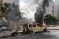 FILE - Cars are on fire after they were hit by rockets from the Gaza Strip in Ashkelon, Israel, on Saturday, Oct. 7, 2023. Maj. Gen. Aharon Haliva, the head of Israel's military intelligence directorate resigned on Monday April 22, 2024 over the failures surrounding Hamas' unprecedented Oct. 7 attack, the military said, becoming the first senior figure to step down over his role in the deadliest assault in Israel's history. (AP Photo/Ohad Zwigenberg, File)