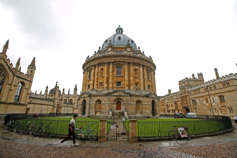 FILE PHOTO: A man walks in front of the buildings of Oxford University