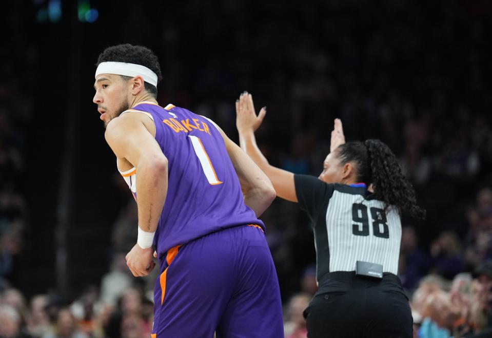 Phoenix Suns guard Devin Booker (1) reacts after making a three point basket against the Atlanta Hawks during the first half at Footprint Center.