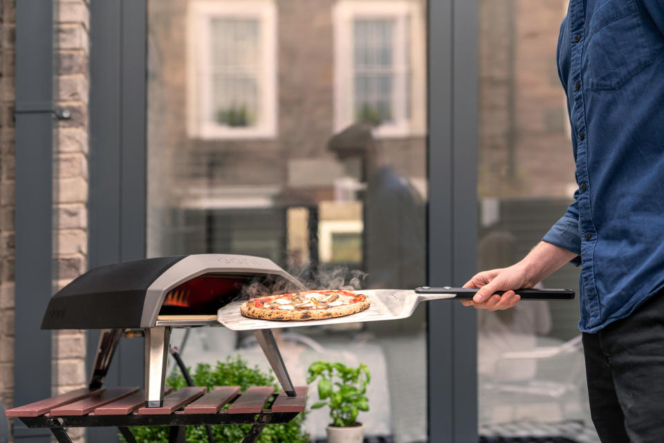 This photo provided by Riverbend Home shows the handy Ooni Koda propane pizza grill, that's ready to go in 15 minutes and cooks pizza in about a minute – as well as roasted fish, steak or vegetables. (Ooni Koda/Riverbend Home via AP)