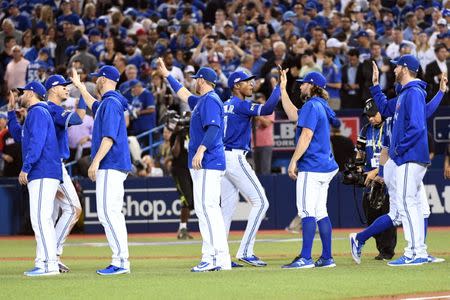 The Toronto Blue Jays celebrate after beating the Cleveland Indians in game four of the 2016 ALCS playoff baseball series at Rogers Centre. Mandatory Credit: Nick Turchiaro-USA TODAY Sports