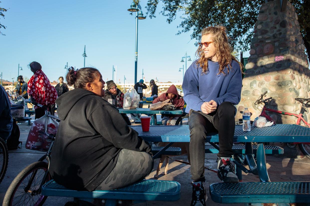 With enough volunteers to serve food, community outreach organizer Austin Davis gets to chat with people at a weekly AZ Hugs for the Houseless event at Tempe Beach Park on Jan. 2, 2022.