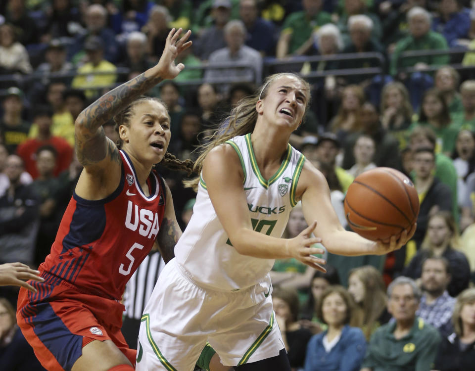 Oregon's Sabrina Ionescu, right, goes up for a shot ahead of United States' Seimone Augustus, left, during the second quarter of an exhibition basketball game in Eugene on Saturday.