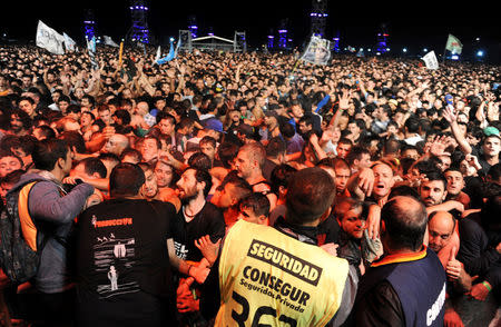 People are pressed against the security barricade in the mosh pit area during a show of Argentine singer Indio Solari in Olavarria, Argentina, March 11, 2017. Picture taken March 11, 2017. REUTERS/Stringer