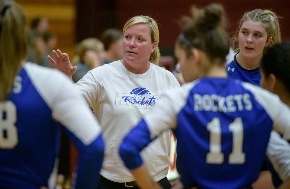 Limestone volleyball coach Shelly Stoner consults with her team during their match against IVC on Wednesday, Aug. 31, 2022 in Chillicothe.