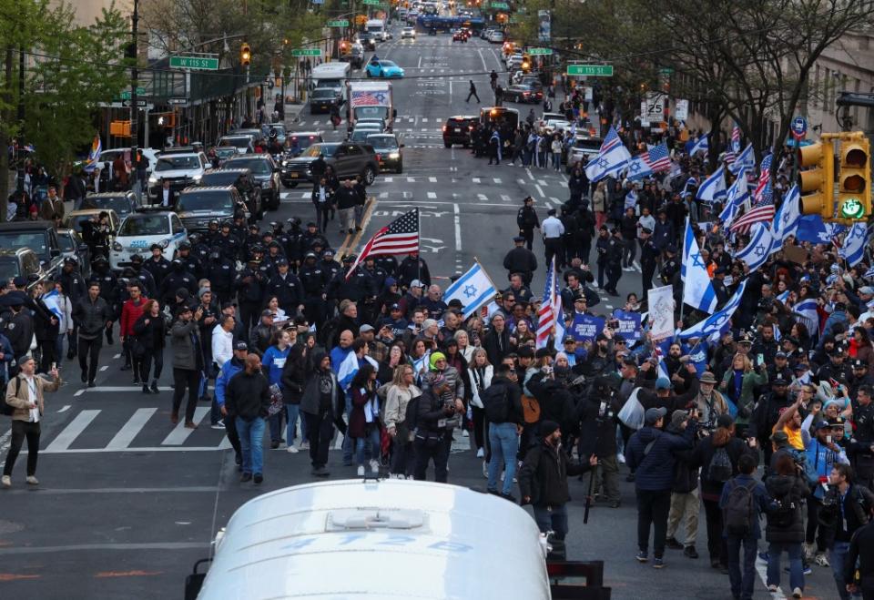 NYPD officials work to clear a street amidst a demonstration in support of Israel outside the Columbia University campus. REUTERS