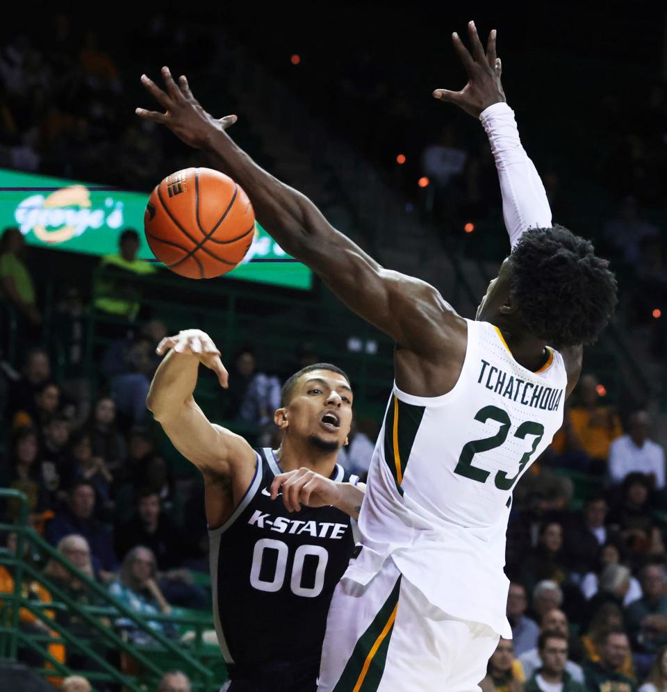 Kansas State guard Mike McGuirl (00) makes a pass around Baylor's Jonathan Tchamwa Tchatchoua (23) in the first half Tuesday night at the Ferrell Center in Waco, Texas.