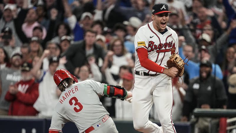 Atlanta Braves first baseman Matt Olson (28) reacts to getting the final out by forcing out Philadelphia Phillies’ Bryce Harper (3) on a fly ball in the ninth inning of Game 2 of the NL Division Series on Monday, Oct. 9, 2023, in Atlanta. The Braves won 5-4.