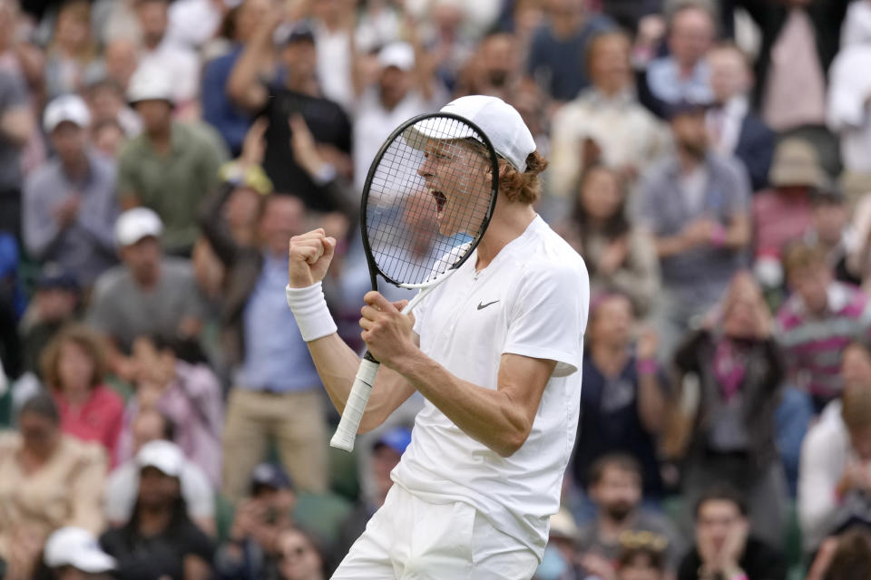 Italy's Jannik Sinner celebrates defeating Spain's Carlos Alcaraz during a men's fourth round singles match on day seven of the Wimbledon tennis championships in London, Sunday, July 3, 2022.(AP Photo/Kirsty Wigglesworth)