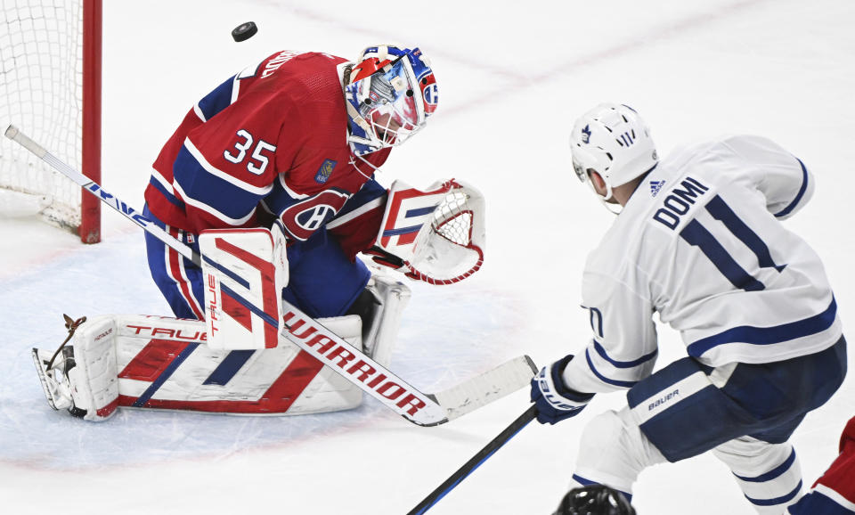 Toronto Maple Leafs' Max Domi scores against Montreal Canadiens goaltender Sam Montembeault during the second period of an NHL hockey game Saturday, March 9, 2024, in Montreal. (Graham Hughes/The Canadian Press via AP)