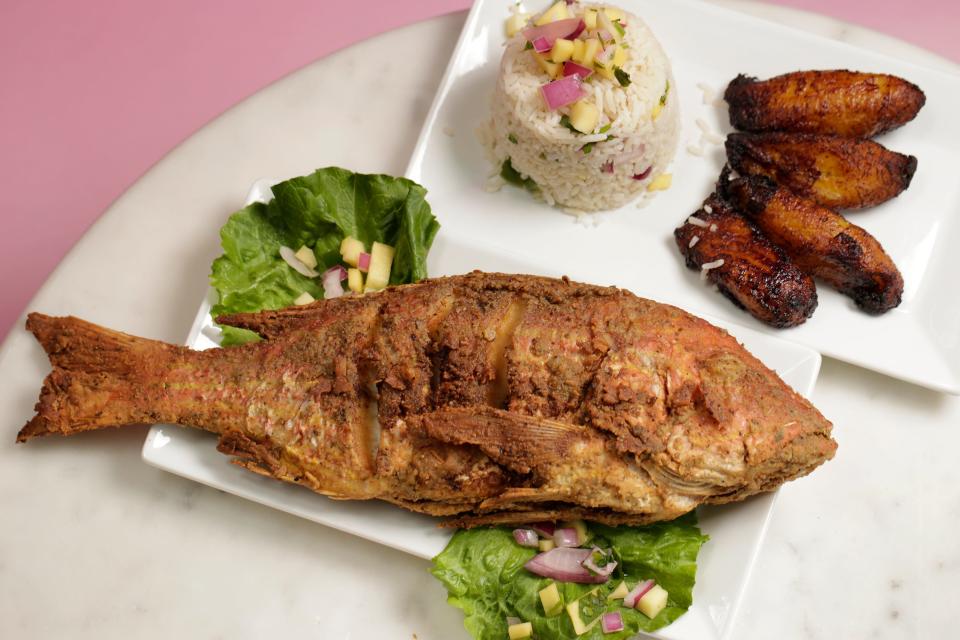 The Whole Snapper Special, a one-pound  fried snapper with coconut rice topped with fresh mango and a side of fried plantains, is a signature dish at Two Sisters and A Deviled Crab seafood restaurant in Orange Park Mall.
