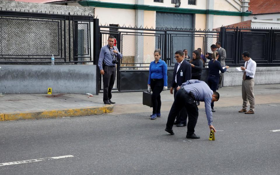 Forensic technicians stand at a crime scene where gunmen apparently shot at several people during an opposition-organised unofficial plebiscite against President Nicolas Maduro's government and his plan to rewrite the constitution, in Caracas, Venezuela July 16 - Credit: REUTERS