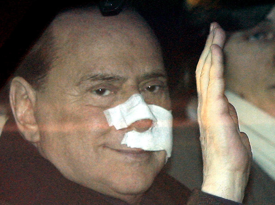 FILE - Italian Premier Silvio Berlusconi waves from his car as he arrives at his home in Arcore, Italy, on Dec.17, 2009. A grim-looking Prime Minister Silvio Berlusconi waved weakly to photographers Thursday as he left a Milan hospital with his face covered in bandages four days after an attack by a mentally ill man at a political rally. Berlusconi, the boastful billionaire media mogul who was Italy's longest-serving premier despite scandals over his sex-fueled parties and allegations of corruption, died, according to Italian media. He was 86. (AP Photo/Luca Bruno, File)