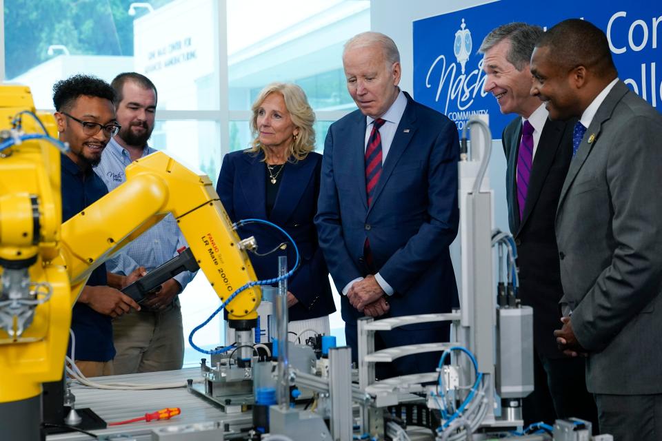 President Joe Biden listens as Bryce Lewis, Industrial Systems Student at Nash Community College, demonstrates how a yellow robot arm can move during a visit to Nash Community College in Rocky Mount, N.C., Friday, June 9, 2023. First lady Jill Biden, North Carolina Gov. Roy Cooper and Rep. Don Davis, D-N.C., look on. Davis co-sponsored a Republican-led bill that reduces Medicare's ability under the Inflation Reduction Act to control drug prices. Every Congressional Democrat in 2022 voted against the bill.