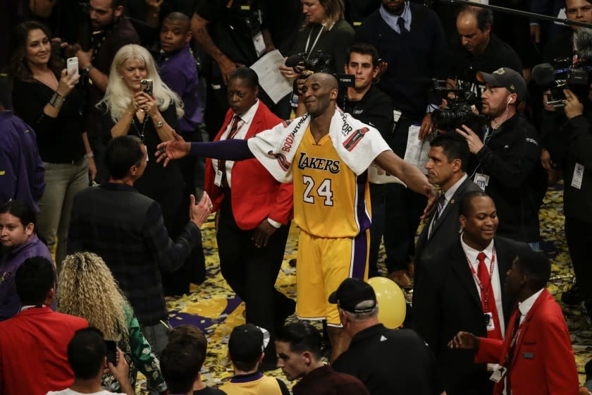 LOS ANGELES, CA, WEDNESDAY, APRIL 13, 2016 - Kobe Bryant moves in to hug his friend and agent Rob Pelinka after playing his last game as a Los Angeles Laker against the Utah Jazz. (Robert Gauthier/Los Angeles Times)