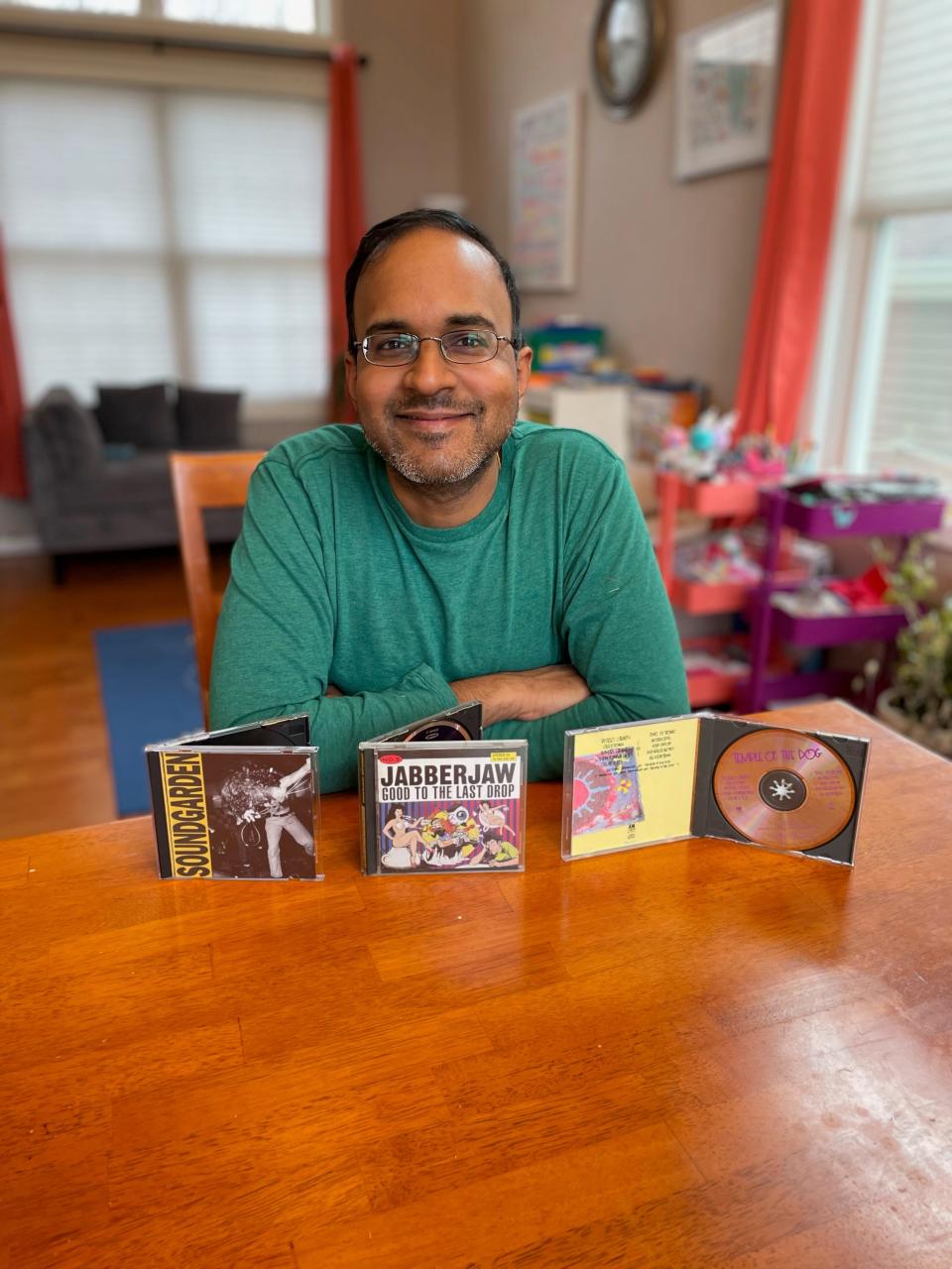 Vasant Ramamurthy, 43, a software engineer from Bloomingdale, Illinois, shown with the first two CDs he bought with his own money:  Soundgarden's 'Louder than Love' and 'Temple of the Dog.' Also shown is his most recent CD purchase, Jabberjaw's 'Good to the Last Drop,' purchased last week.