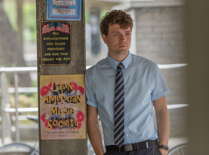 Austin Swift leaning against cement pole in I.T. movie