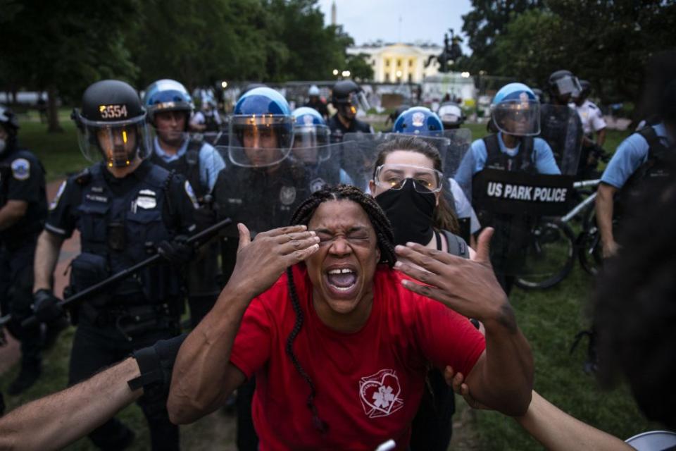 A woman reacts to being hit with pepper spray as protesters clash with U.S. Park Police after they attempted to pull down the statue of Andrew Jackson in Lafayette Square near the White House on June 22, 2020 in Washington, DC. (Photo by Tasos Katopodis /Getty Images)