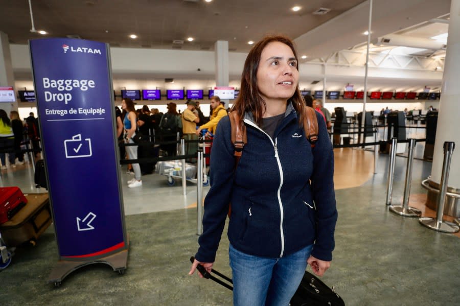 Passenger Janet Baker prepares to check in at Auckland, New Zealand airport for a LATAM Airlines flight to Santiago, Chile, Tuesday, March 12, 2024. At least 50 people were injured Monday by what officials described as a “strong movement” on a Chilean plane traveling from Sydney to Auckland. Baker was on the flight Monday. (Dean Purcell/New Zealand Herald via AP)