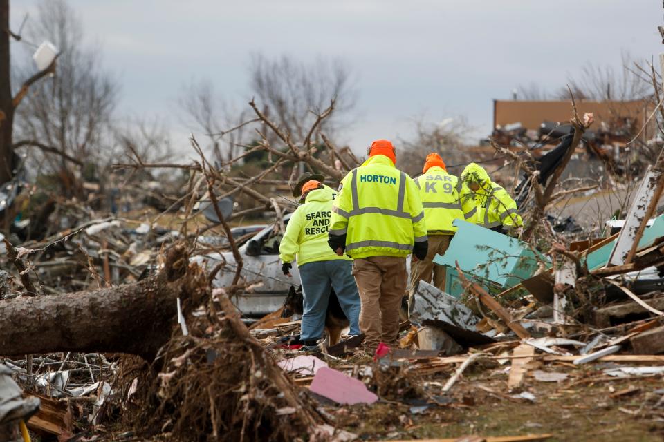 Davis County Search and Rescue members sift through the wreckage from a tornado that touched down in the neighborhood along Pine Street in Dawson Springs, KY., on Saturday, Dec. 11, 2021. 