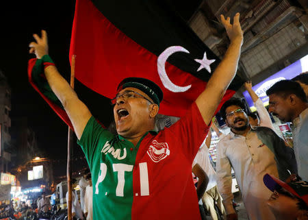 Supporters of Pakistan Tehreek-e-Insaf (PTI) political party celebrate along the road during the general election in Karachi, Pakistan July 25, 2018. REUTERS/Akhtar Soomro