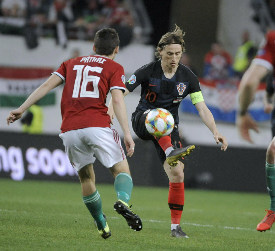 Mate Patkai , left, of Hungary and Luka Modric of Croatia in action during the UEFA EURO 2020 qualifying soccer match between Hungary and Croatia in Groupama Arena in Budapest, Hungary, Sunday, March 24, 2019. (Balazs Czagany/MTI via AP)