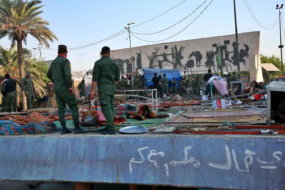 Security forces remove protesters' tents in Tahrir Square, Baghdad, Iraq, Saturday, Oct. 31, 2020. Iraqi security forces reopened Saturday Tahrir Square, the epicenter of the long-running anti-government protest movement and Al-Jumhuriyah Bridge, which was sealed off by protesters since the protests began in October last year. (AP Photo/Khalid Mohammed)