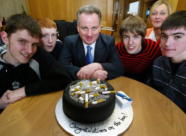 Jack McConnell and young people gathered around an ash tray